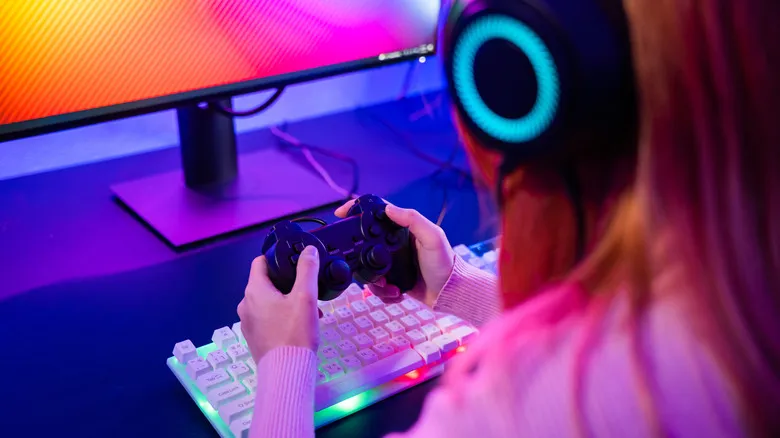 A person gaming with a controller in hand