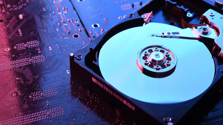 an exposed hdd drive sitting on a circuit board