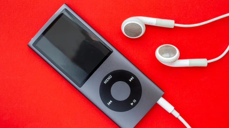 An iPod Nano with headphones on red background