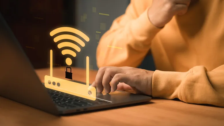 Wi-Fi symbol over a router graphic on a computer with a person interacting with it