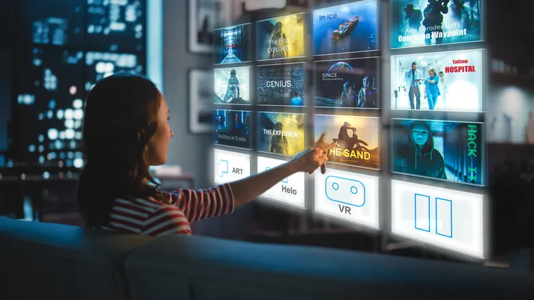 A woman choosing a TV show from a holographic interface