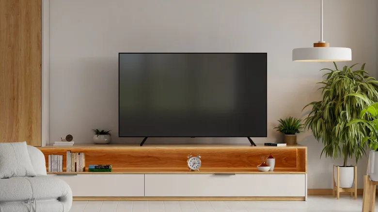 Modern living room with a TV on a wooden media console.