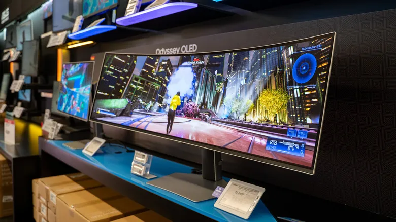 Samsung Odyssey OLED ultrawide monitor on display running a game in store