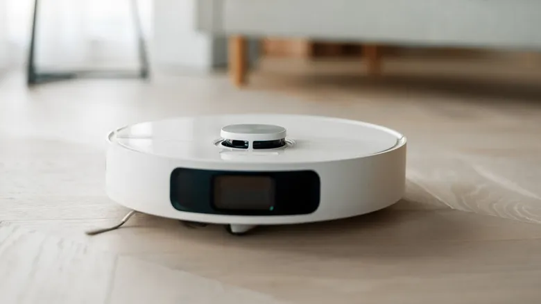 Robot vacuum cleaning hardwood floor in living room