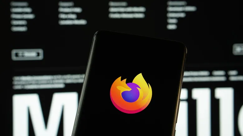 Firefox logo on smartphone in front of Firefox browser on computer