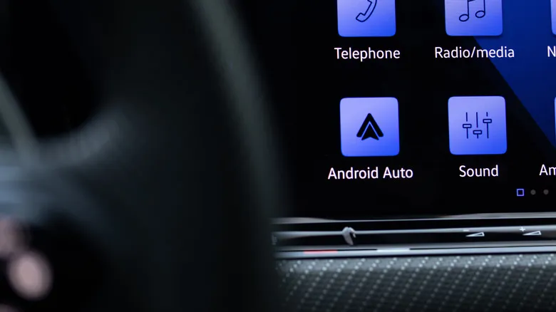 Android Auto icon closeup on the dashboard display of a luxury vehicle.