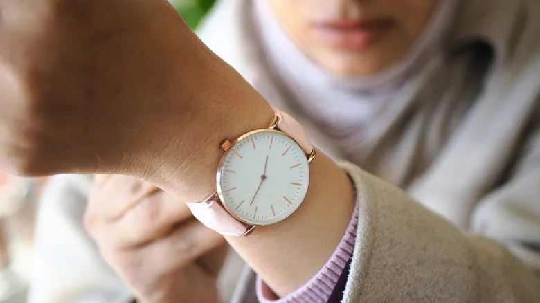 a person wearing a traditional wrist watch