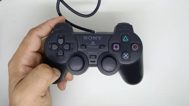 Holding the DualShock 2 controller