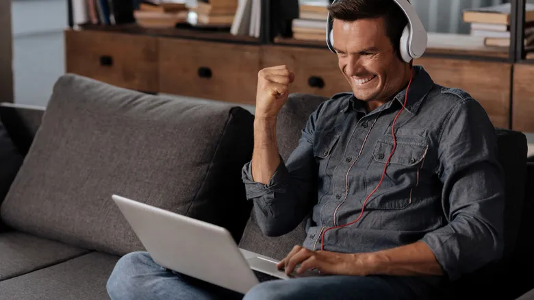 Person playing video games on laptop