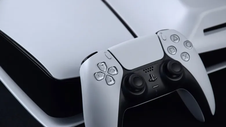 A close-up of a PlayStation 5 console and controller
