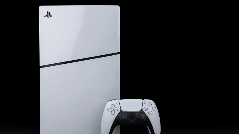 A PlayStation 5 console frontal view in a vertical position next to a DualSense controller