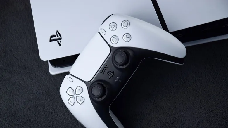 PlayStation 5 DualSense controller resting on top of PS5 console