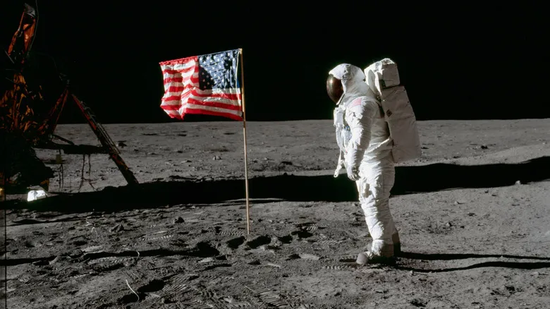 Buzz Aldrin beside an American flag on the Moon.