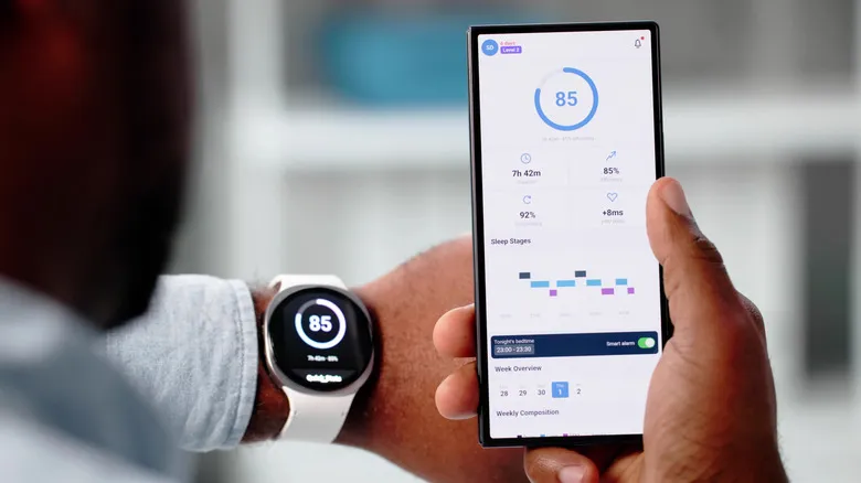 A person using a smartwatch along with a smartphone fitness app