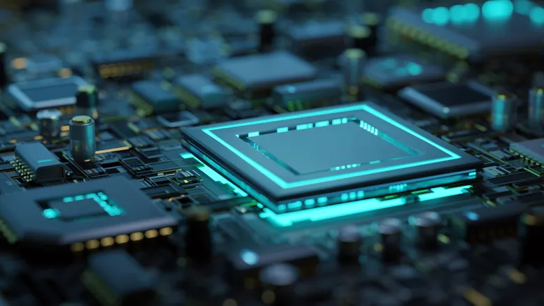 Close up of a motherboard focused on a chip in the center that's glowing blue