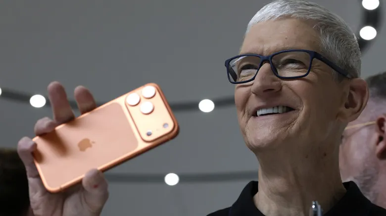 Apple CEO Tim Cook holding an iPhone 17 Pro