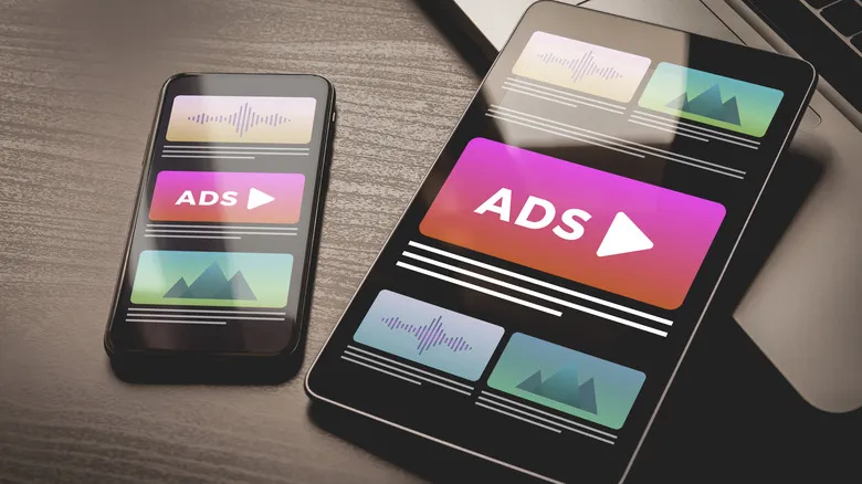 a smartphone and a tablet showing ads in the middle of the screen with generic images of pictures and text