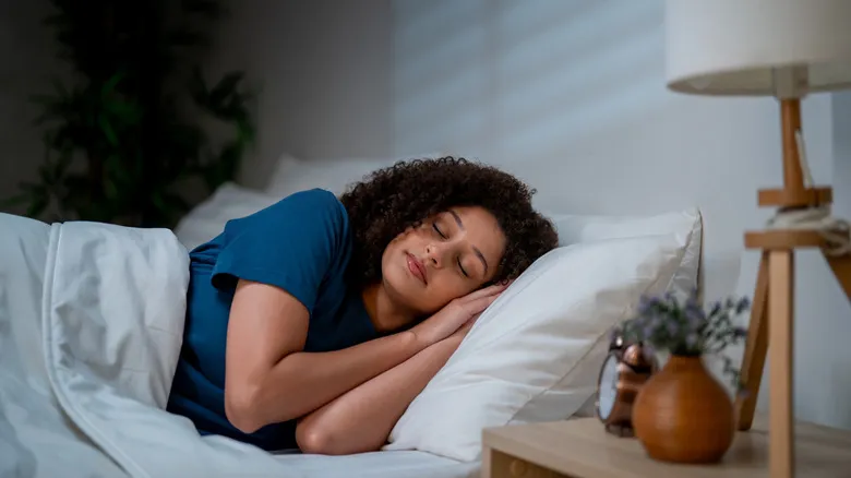 A woman sleeping soundly in a bed