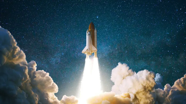 A space shuttle flying up to space