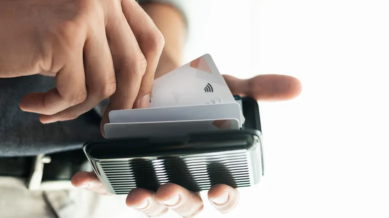 A man pulling a credit card out of his RFID blocking wallet